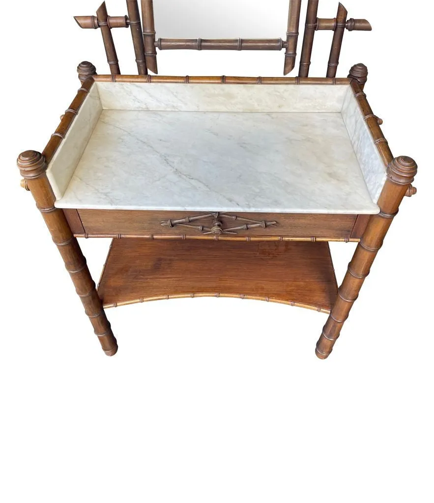 A 1920s faux bamboo and white Carrara marble dressing table with central mirror and drawer.