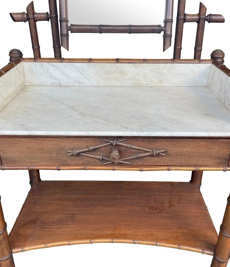A 1920s faux bamboo and white Carrara marble dressing table with central mirror and drawer.