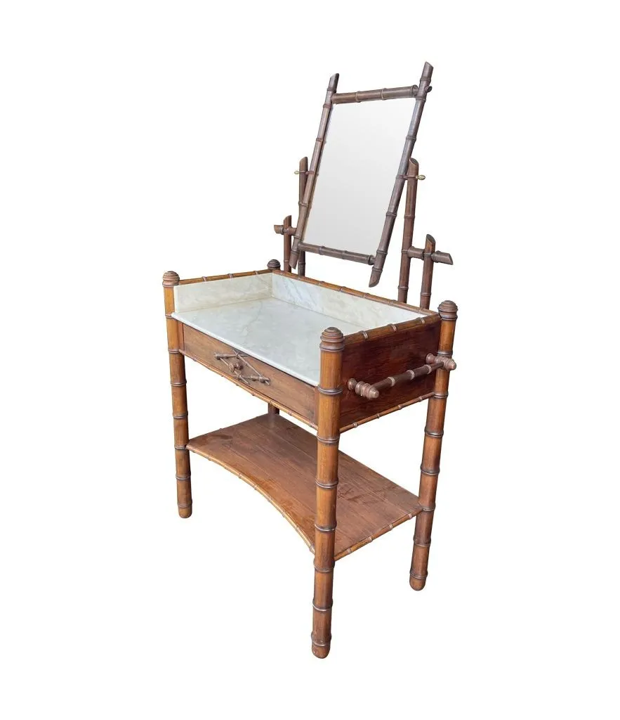 A 1920s faux bamboo and white Carrara marble dressing table with central mirror and drawer.