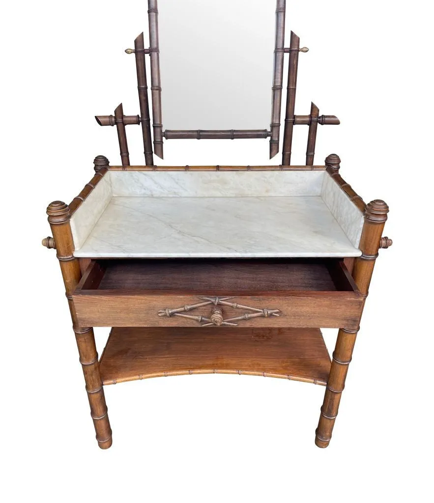 A 1920s faux bamboo and white Carrara marble dressing table with central mirror and drawer.