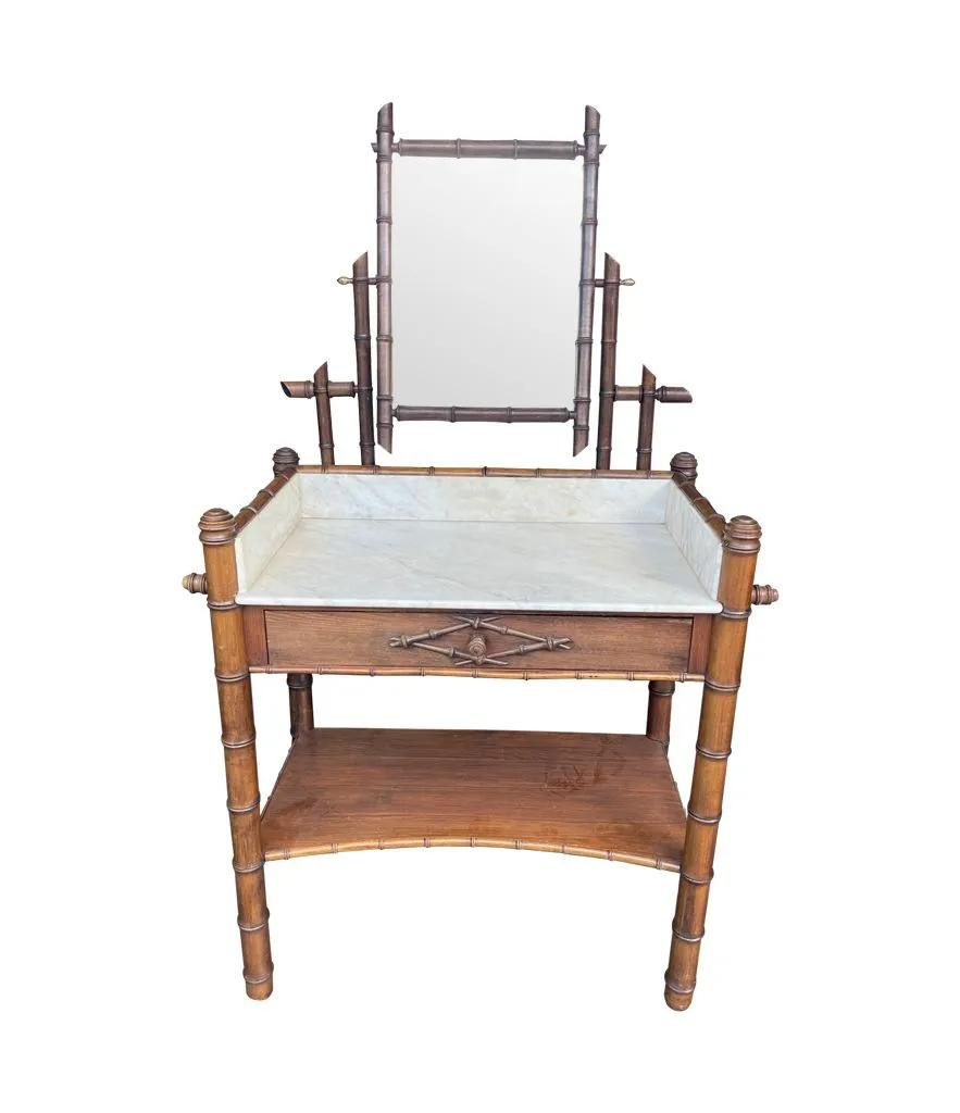 A 1920s faux bamboo and white Carrara marble dressing table with central mirror and drawer.