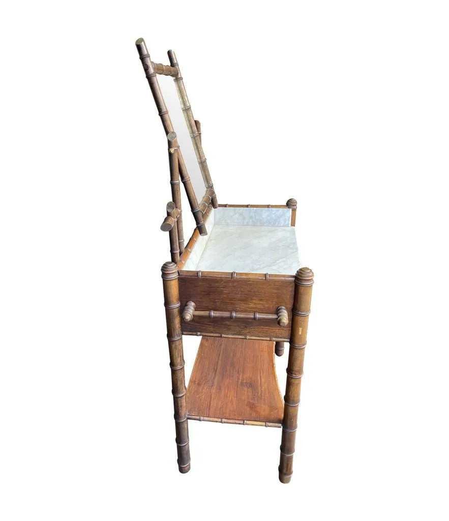 A 1920s faux bamboo and white Carrara marble dressing table with central mirror and drawer.
